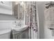 Clean bathroom with modern fixtures, decorative mirror, and shower with a stylish curtain at 511 27Th N Ave, St Petersburg, FL 33704