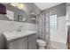 Charming bathroom featuring a vanity with storage, decorative shelves, and a shower with a decorative curtain at 511 27Th N Ave, St Petersburg, FL 33704