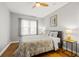 Bright bedroom featuring hardwood floors, a ceiling fan, bedside tables, and large window at 511 27Th N Ave, St Petersburg, FL 33704