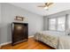Cozy bedroom features hardwood floors, a ceiling fan, natural light from the window, and a dresser at 511 27Th N Ave, St Petersburg, FL 33704