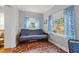 Cozy bedroom featuring unique tile floors, a futon, and plenty of natural light at 511 27Th N Ave, St Petersburg, FL 33704