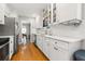 Bright kitchen featuring white cabinets, stainless steel appliances, hardwood floors and a view into the dining room at 511 27Th N Ave, St Petersburg, FL 33704