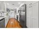 Modern kitchen with white cabinets, stainless steel appliances, hardwood floors, and ample counter space at 511 27Th N Ave, St Petersburg, FL 33704