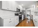Spacious kitchen with stainless steel appliances, white cabinets, hardwood floors and an open view at 511 27Th N Ave, St Petersburg, FL 33704