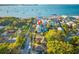 Stunning aerial view pinpoints a coastal home nestled amongst colorful neighborhood, bay, and scenic pier at 5402 31St S Ave, Gulfport, FL 33707