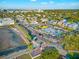 Aerial view of a colorful coastal town featuring storefronts, pedestrian walkways, palm trees, and blue skies at 5402 31St S Ave, Gulfport, FL 33707