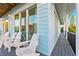 Charming balcony with light blue siding featuring seating and relaxing space at 5402 31St S Ave, Gulfport, FL 33707