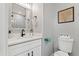 Elegant bathroom with a ornate mirror, marble countertop, and a toilet at 5402 31St S Ave, Gulfport, FL 33707