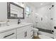 Modern bathroom featuring a marble walk-in shower, black fixtures and a white vanity at 5402 31St S Ave, Gulfport, FL 33707