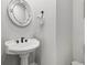 Traditional bathroom featuring a pedestal sink and decorative mirror at 5402 31St S Ave, Gulfport, FL 33707