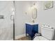 Elegant bathroom featuring a blue vanity, gold fixtures, and a glass shower at 5402 31St S Ave, Gulfport, FL 33707