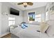 Bright bedroom featuring a ceiling fan, TV, and a window with a view of the outdoors at 5402 31St S Ave, Gulfport, FL 33707