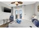 Bedroom with a comfortable queen bed, balcony, and wall-mounted television for relaxation at 5402 31St S Ave, Gulfport, FL 33707