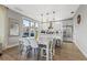 Chic dining area adjacent to the kitchen, featuring modern furnishings and ample natural light from large windows at 5402 31St S Ave, Gulfport, FL 33707