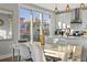 Bright dining area with sleek chairs and modern pendant lighting adjacent to the kitchen with stainless appliances at 5402 31St S Ave, Gulfport, FL 33707