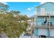 Three-story home with double balconies offers a glimpse of the scenic waterfront from its elevated position at 5402 31St S Ave, Gulfport, FL 33707