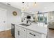 Modern kitchen featuring a spacious island with a double sink and breakfast bar that overlooks the living area at 5402 31St S Ave, Gulfport, FL 33707