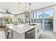 Open-concept kitchen with a stylish island, modern appliances, and access to an outdoor patio, perfect for entertaining at 5402 31St S Ave, Gulfport, FL 33707