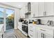 Well-equipped kitchen with stainless steel appliances, quartz countertops, and sleek white cabinets, offering ample storage at 5402 31St S Ave, Gulfport, FL 33707