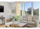 Bright living room featuring a comfortable sofa, stylish decor, and a large window offering scenic views at 5402 31St S Ave, Gulfport, FL 33707