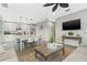 Open-concept living room showcases a modern kitchen, dining area, and entertainment space, perfect for gatherings at 5402 31St S Ave, Gulfport, FL 33707