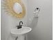 Stylish powder room features a modern vanity, decorative mirror, and sleek black hardware at 5402 31St S Ave, Gulfport, FL 33707