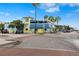 Charming multi-story restaurant with blue and yellow exterior with outdoor seating and palm trees in view at 5402 31St S Ave, Gulfport, FL 33707