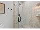 Modern shower featuring tiled walls, a glass door, and sleek fixtures at 5402 31St S Ave, Gulfport, FL 33707