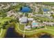 Aerial view of community center featuring swimming pool, outdoor seating, modern architectural details and lake views at 5614 Silver Sun Dr, Apollo Beach, FL 33572