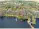 Aerial view shows lot boundaries with access to a serene lake with docks, perfect for a lakeside retreat at 6302 Fitzgerald Rd, Odessa, FL 33556