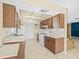 Kitchen with tile floors, white countertops and white appliances at 6302 Fitzgerald Rd, Odessa, FL 33556