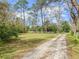 A beautiful lot with a long driveway leading to a serene, private homesite at 6302 Fitzgerald Rd, Odessa, FL 33556