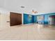 Open living space with tile floors, ceiling fan, and a built-in bench beneath a large window at 6302 Fitzgerald Rd, Odessa, FL 33556