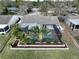 Aerial view of backyard with pool, screened enclosure, landscaping, and privacy fence at 641 Bay Lake Trl, Oldsmar, FL 34677