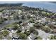 Wide aerial view showcasing waterfront community with mature trees, homes, and a nearby body of water at 641 Bay Lake Trl, Oldsmar, FL 34677