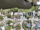 Aerial view of neighborhood showcasing pond, landscaping, and nearby streets at 641 Bay Lake Trl, Oldsmar, FL 34677