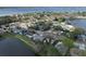 Stunning aerial view of a neighborhood with lush trees and a beautiful lake in the background at 641 Bay Lake Trl, Oldsmar, FL 34677