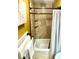 Tiled bathtub and shower combination with bronze fixtures and built-in shelf at 641 Bay Lake Trl, Oldsmar, FL 34677