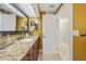 Bathroom featuring granite vanity, a large mirror, and a doorway leading to other areas of the home at 641 Bay Lake Trl, Oldsmar, FL 34677