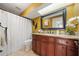Well-lit bathroom features a granite-topped vanity and a shower-tub combination with a white shower curtain at 641 Bay Lake Trl, Oldsmar, FL 34677