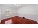 This bedroom features hardwood floors, neutral walls, and a window bringing in natural light at 641 Bay Lake Trl, Oldsmar, FL 34677