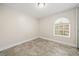 Bright, airy bedroom features a unique arched window and neutral paint colors for a soothing ambiance at 641 Bay Lake Trl, Oldsmar, FL 34677