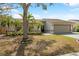 Well-maintained single-Gathering home with a spacious two-car garage and vibrant landscaping in front yard at 641 Bay Lake Trl, Oldsmar, FL 34677