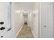 Well-lit hallway with tile flooring, closet space, and a decorative glass front door at 641 Bay Lake Trl, Oldsmar, FL 34677