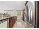 Kitchen with stainless appliances and stainless sink set in granite counters, cherry cabinets at 641 Bay Lake Trl, Oldsmar, FL 34677