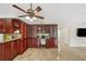 Kitchen offers cherry cabinets, granite countertops, and built-in desk space for working from home at 641 Bay Lake Trl, Oldsmar, FL 34677