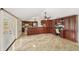 Spacious kitchen with cherry cabinets, granite counters, and room for a table or a desk space at 641 Bay Lake Trl, Oldsmar, FL 34677