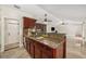 Kitchen with cherry cabinets, granite counters and stainless sink with stainless dishwasher appliance at 641 Bay Lake Trl, Oldsmar, FL 34677