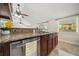 Kitchen with stainless appliances, granite countertops, cherry cabinets and view to outside at 641 Bay Lake Trl, Oldsmar, FL 34677
