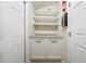Laundry room featuring a countertop, cabinets, and shelving for storage, and a door to outside at 641 Bay Lake Trl, Oldsmar, FL 34677